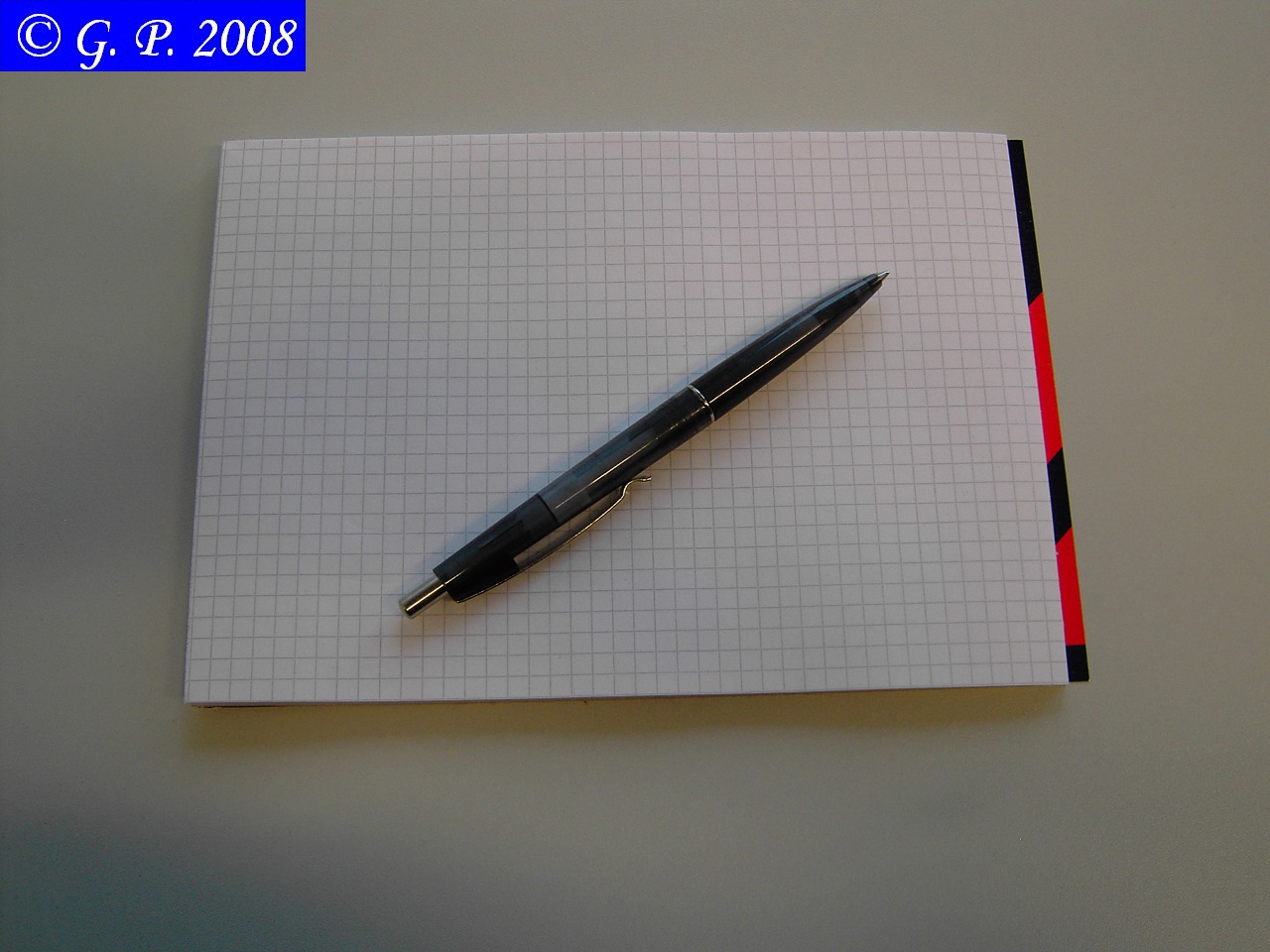 a pen resting on top of a notepad