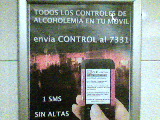 a cell phone is being held in front of a spanish advertit