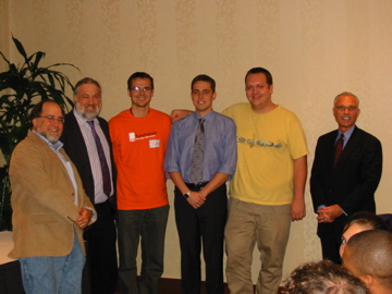 people in suit standing close together in a room