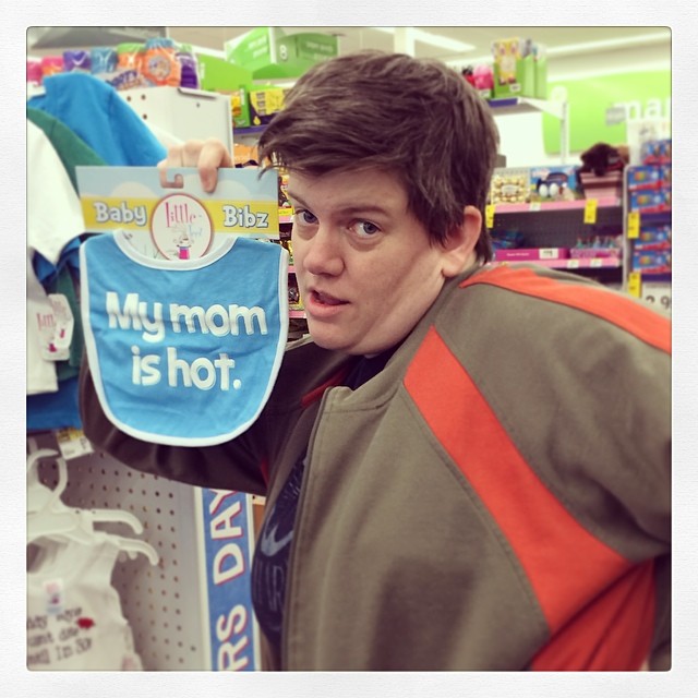 a boy showing off a bib in the store