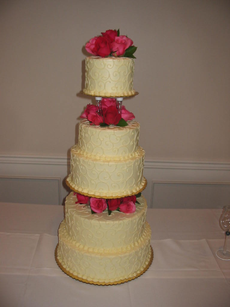 the three tiered cake has flowers in it