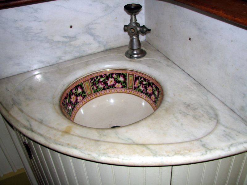 a bathroom sink with a marble top and faucet
