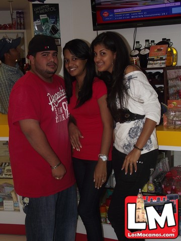 three people posing together with one woman wearing a red shirt