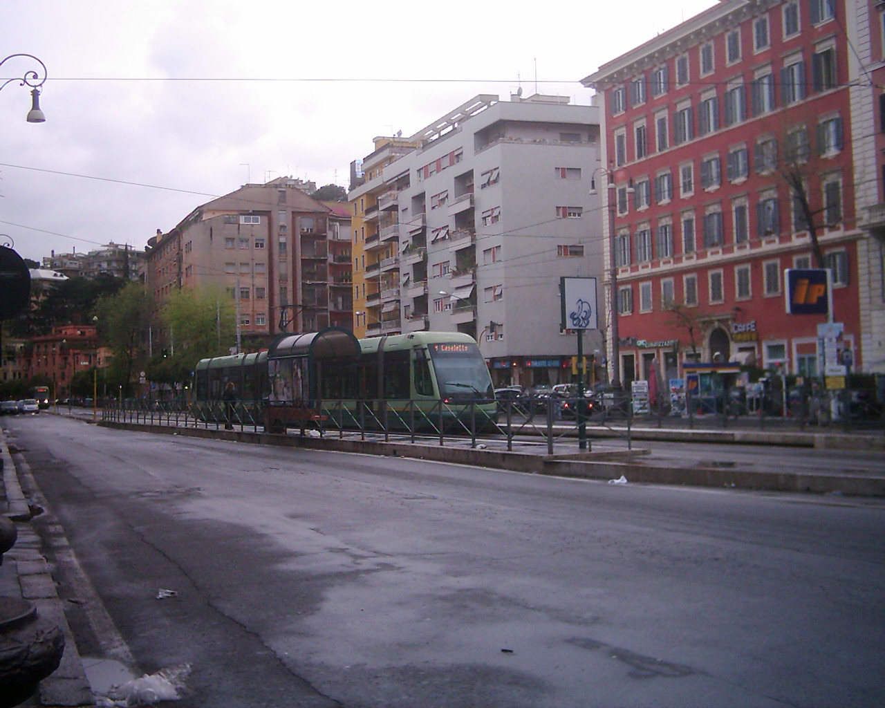 a bus on a street next to tall buildings