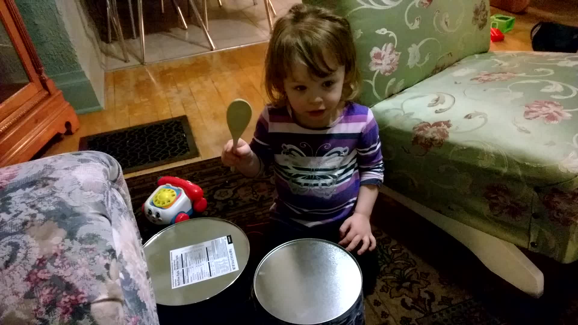 a child with a fork and some plates