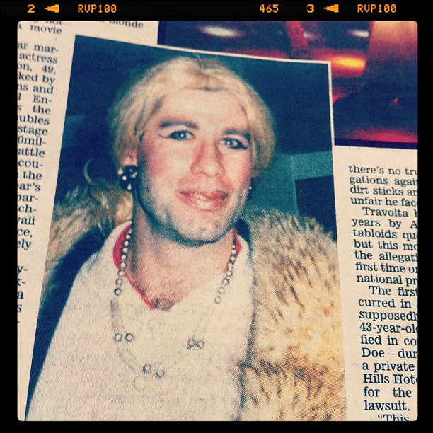a man with blond hair and piercings on a newspaper page