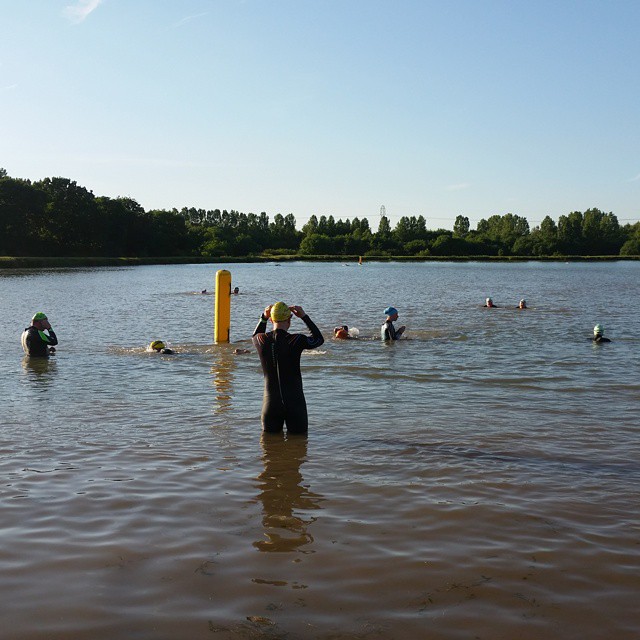 a man in water with a wet suit and several others