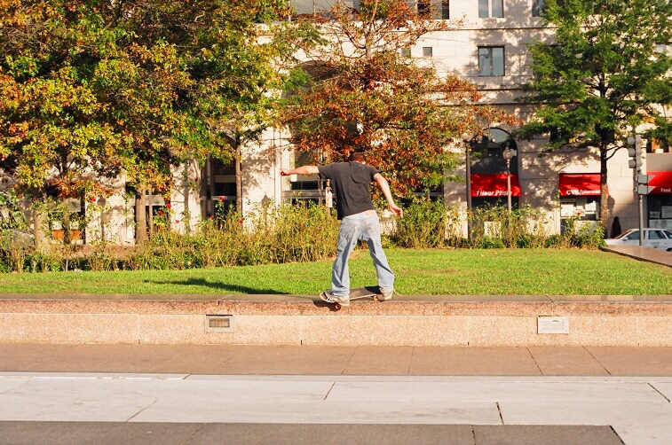 a person riding a skateboard down a road