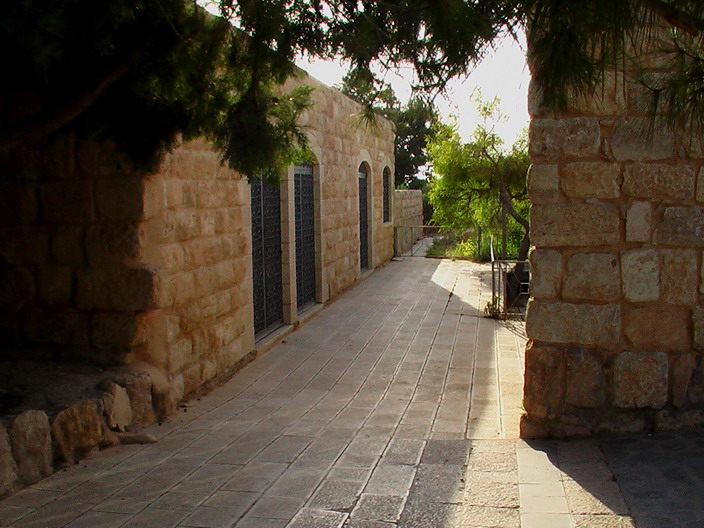a long walkway is shown between two brick walls