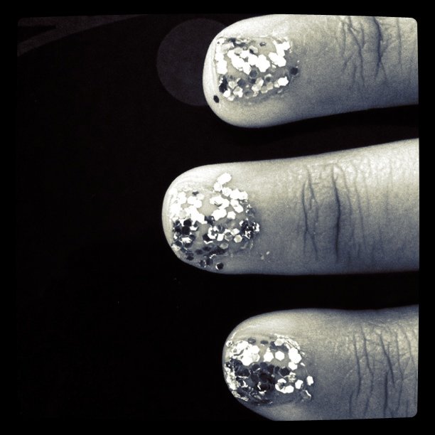 a manicure with silver glitters on it