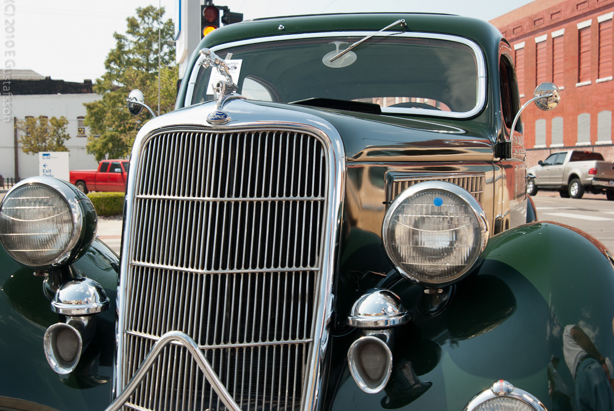 an old time car is parked in the street