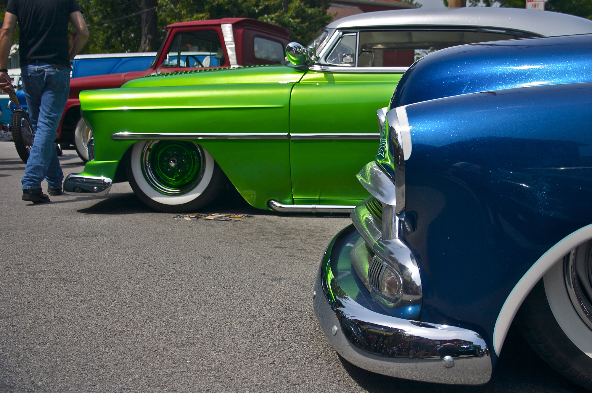 several old cars lined up at a car show