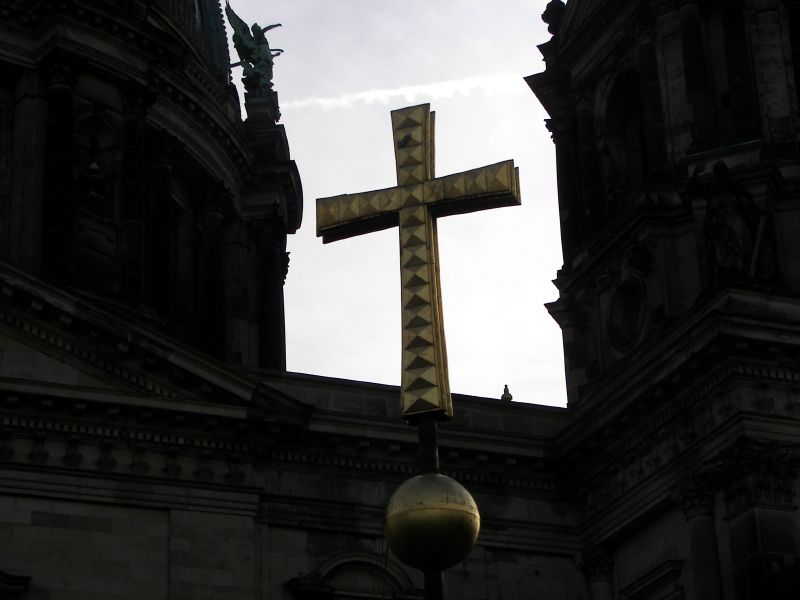 a cross is hanging on the top of a building