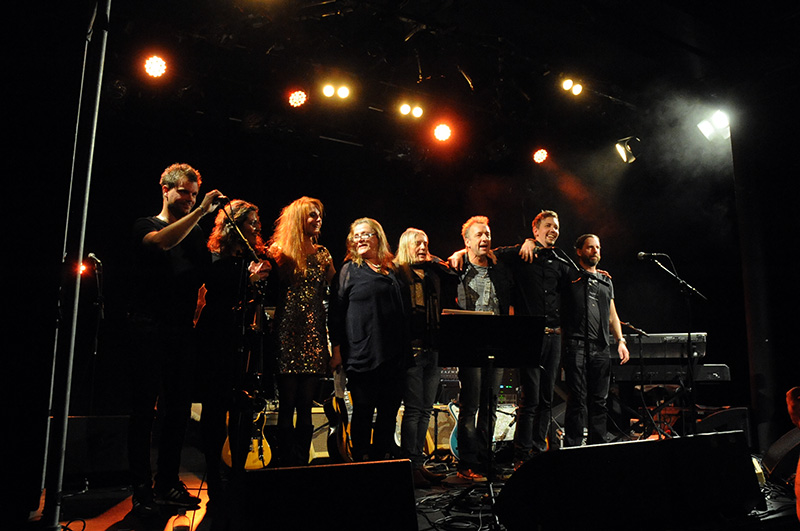 a group of people standing on top of a stage