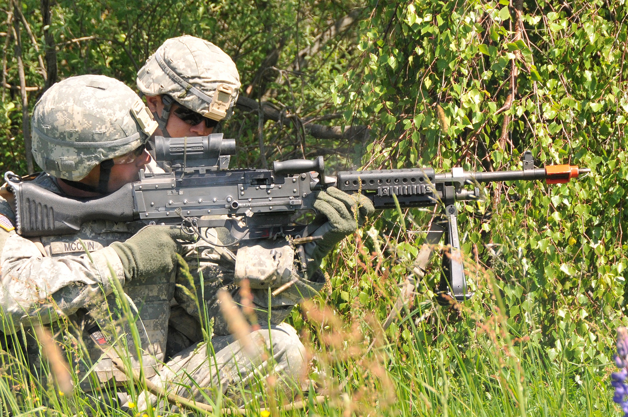 two soldiers aiming their rifle on the side