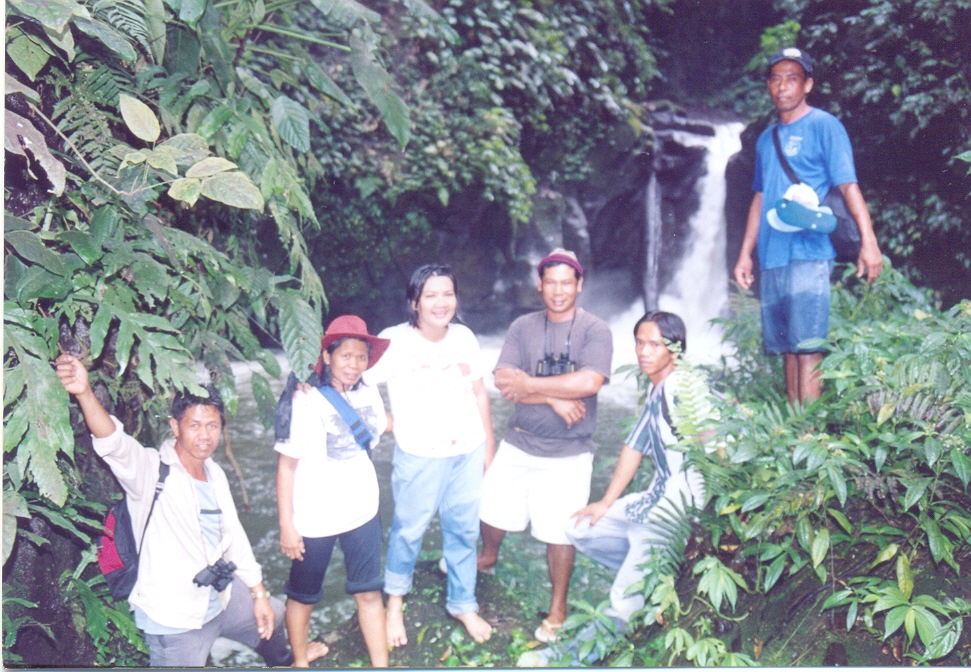 a group of people in a jungle posing for a po