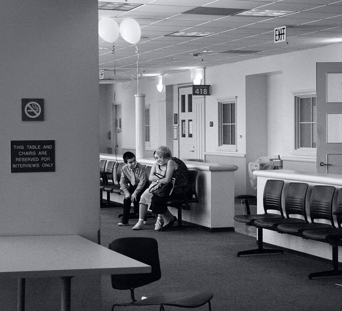 two people sitting on benches in the waiting room