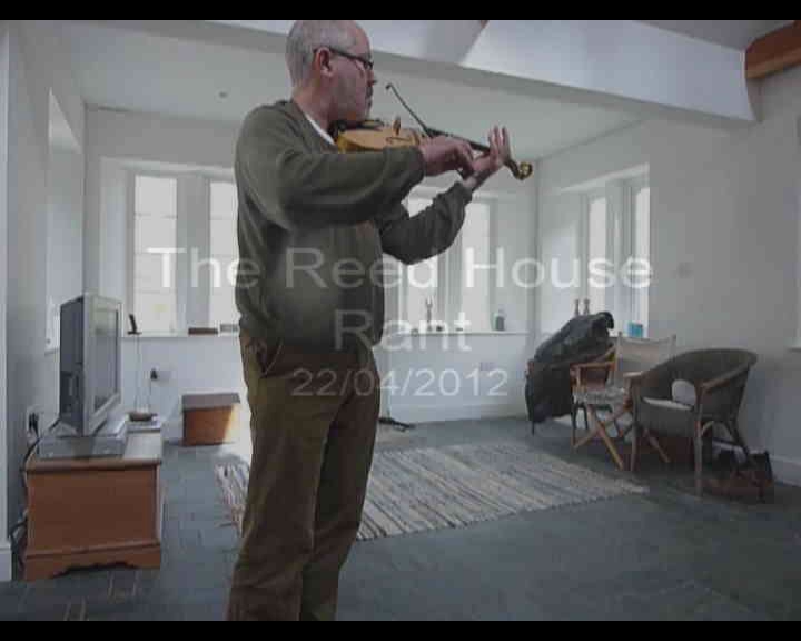 a man playing the violin in an apartment