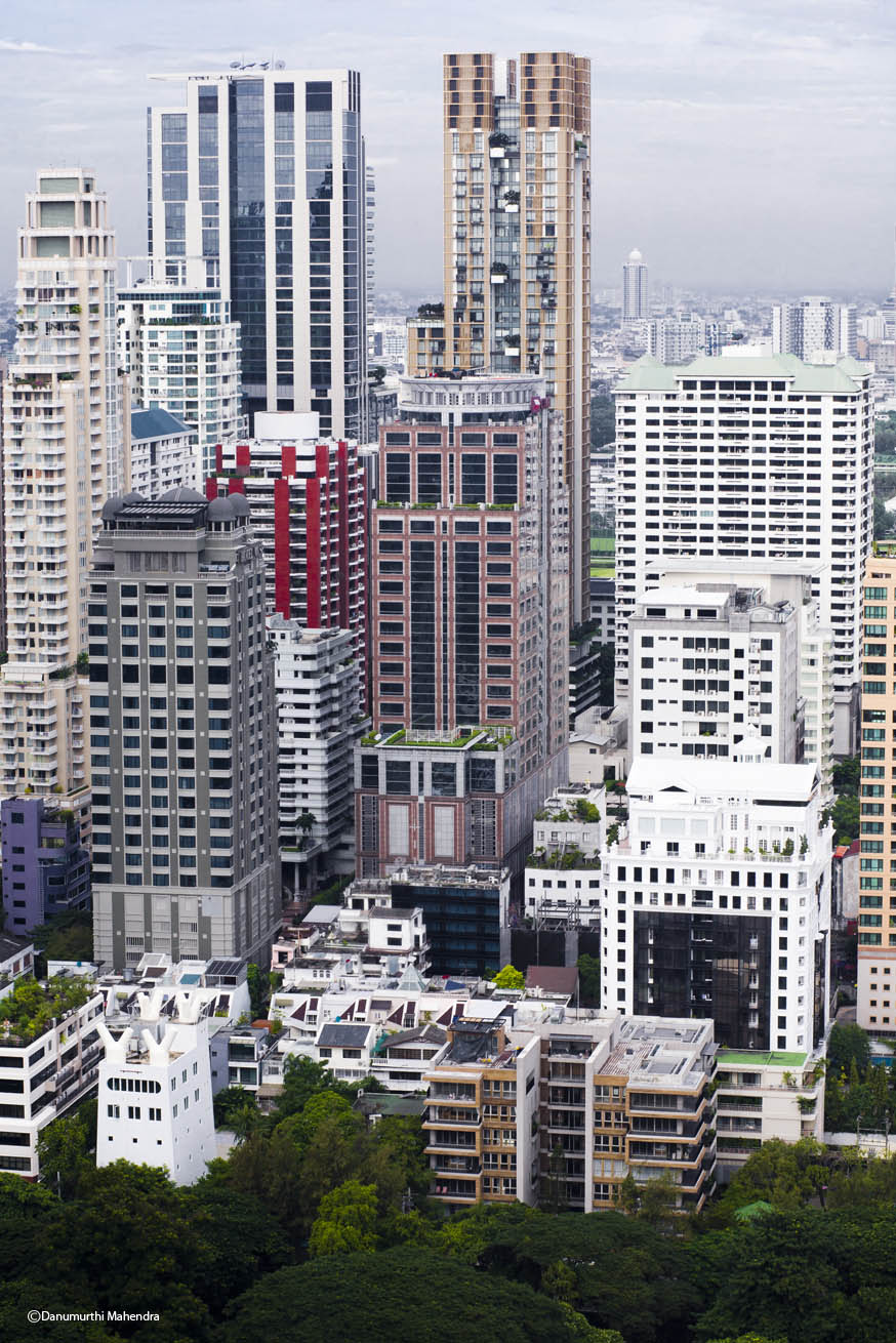 high rise buildings in a city and a cloudy sky