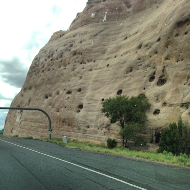 a large rock on the side of a highway