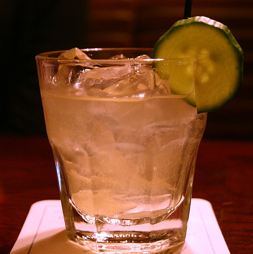 glass full of ice water with a lime wedge on top