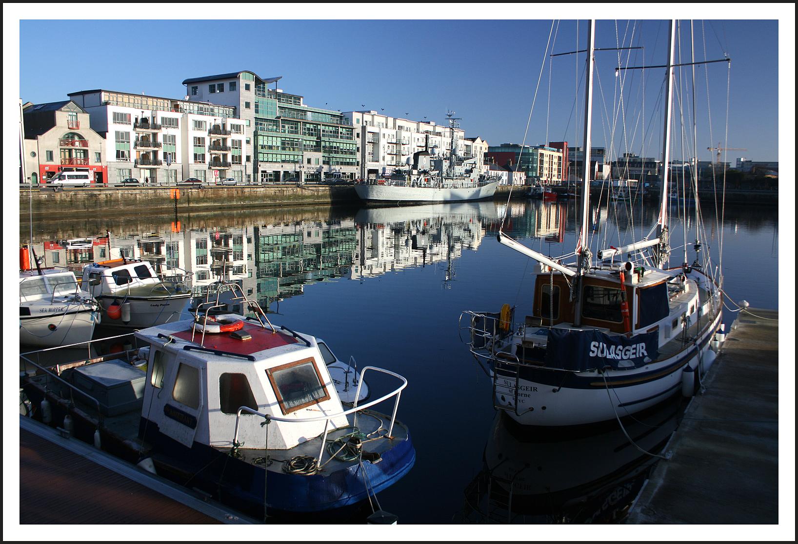 boats sitting in the water in front of buildings