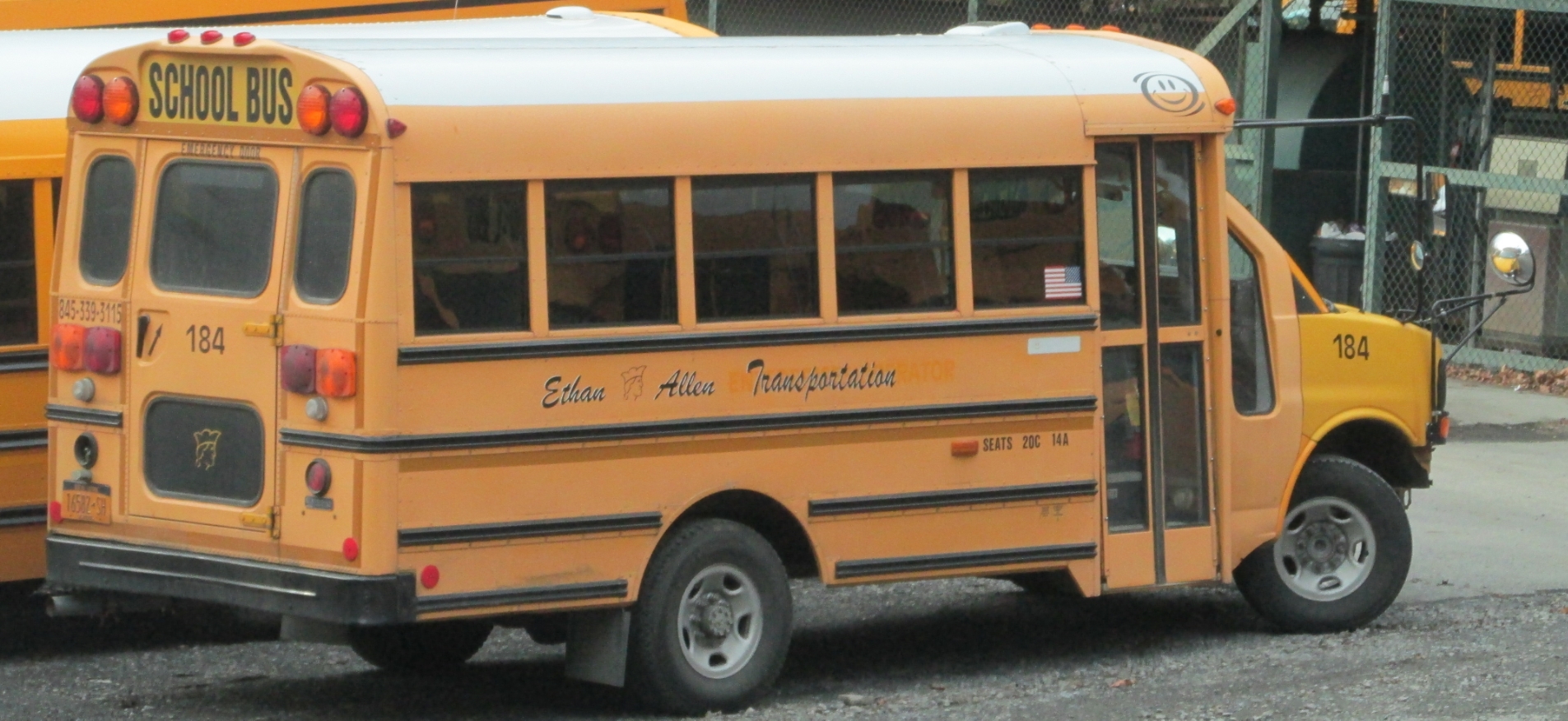 two yellow school buses are parked on the street