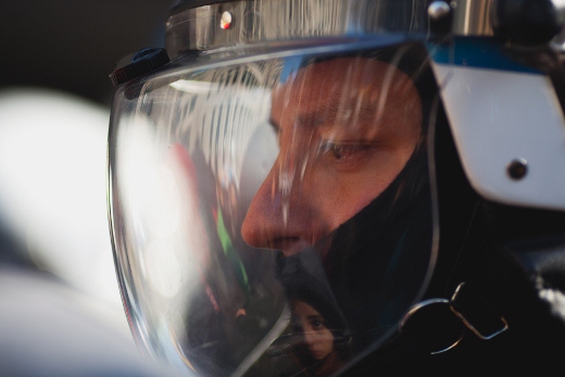 a man wearing a helmet while sitting in the back of a car