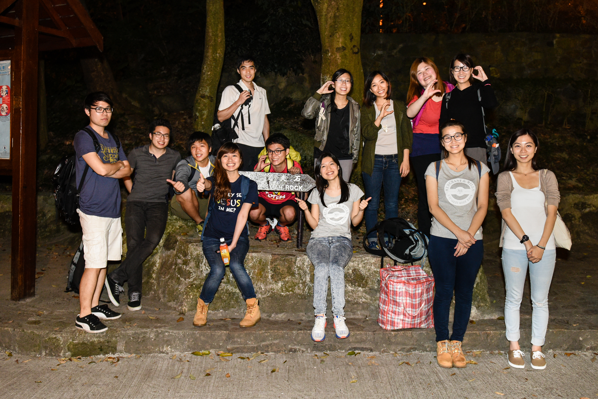 a group of people posing for a picture at night