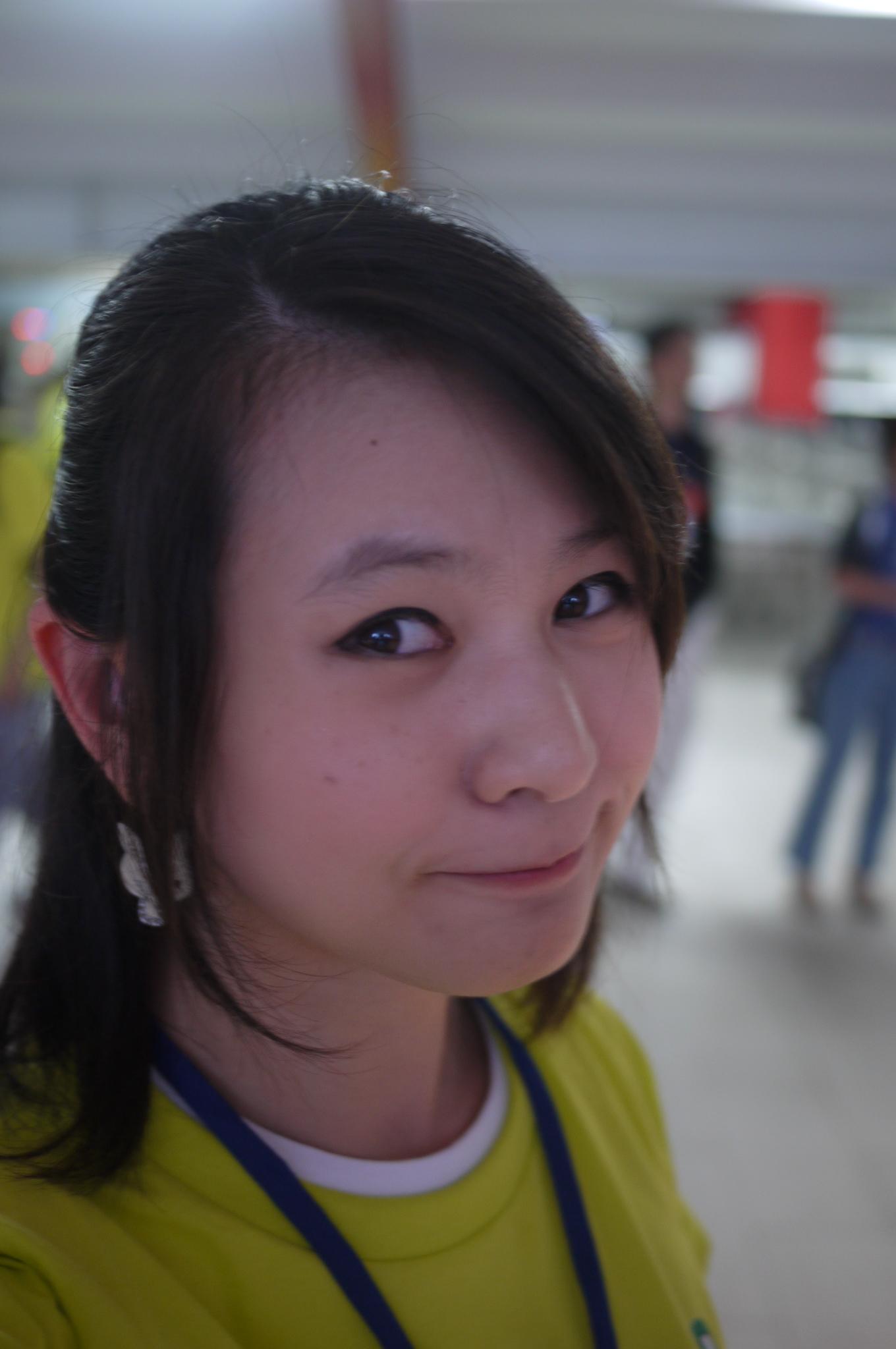 a beautiful young lady wearing a yellow shirt