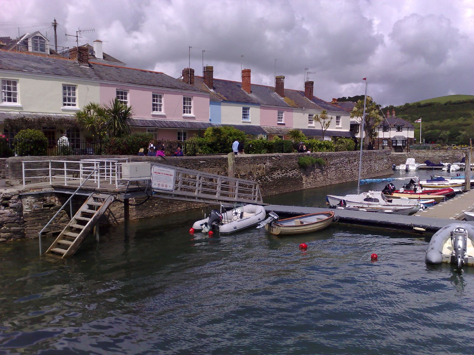 there is a row of boats docked at a dock