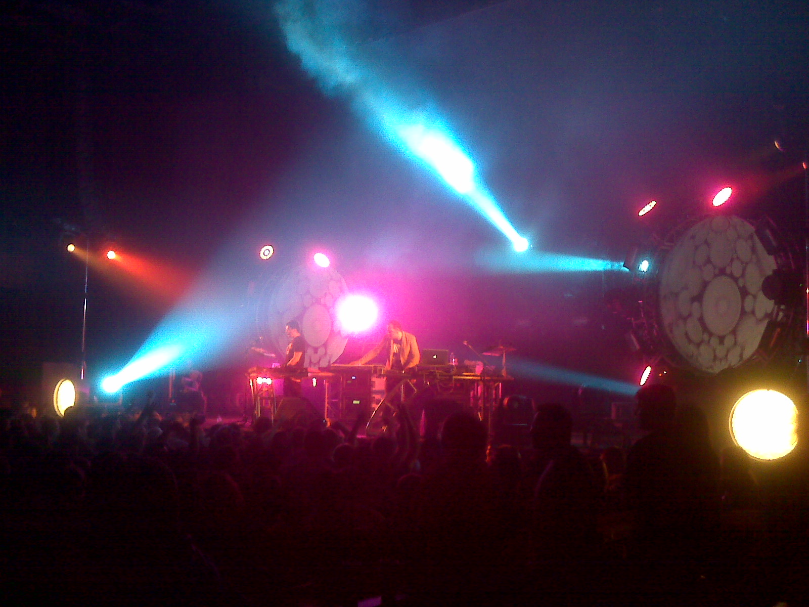 an electronic stage with bright colored lights behind