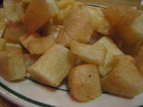 a white plate topped with lots of potatoes