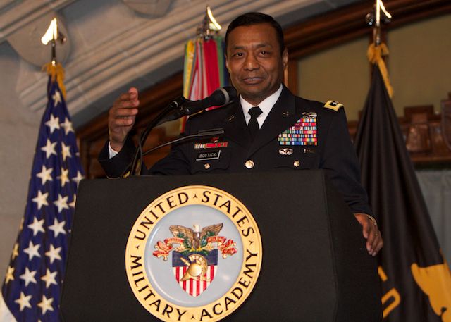 a man in military uniform standing behind a podium