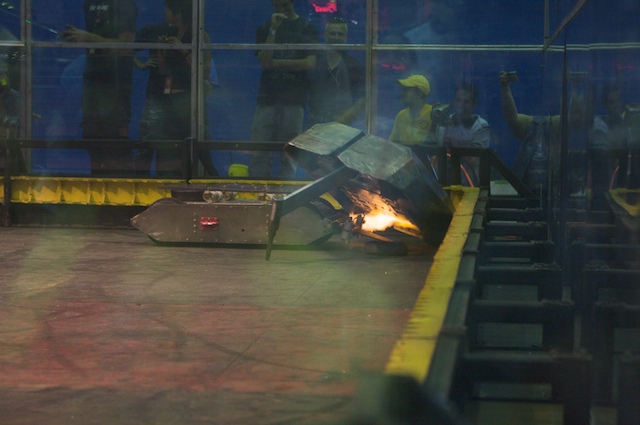 a burning piece on a conveyor belt in a building