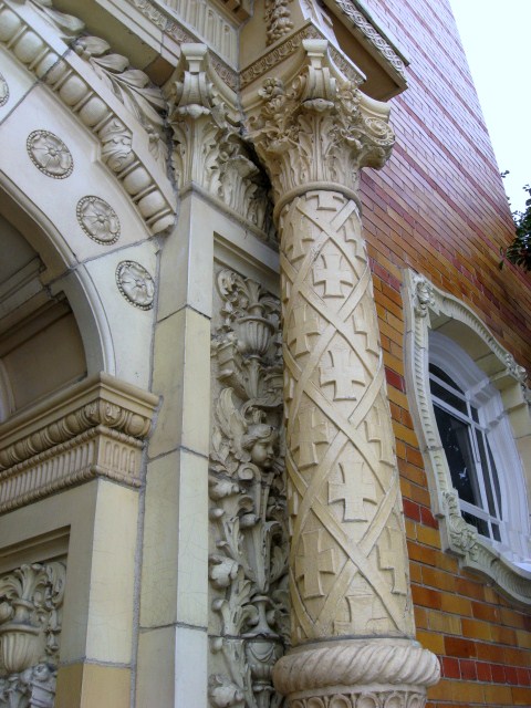 an antique architecture sits on display near a brick building