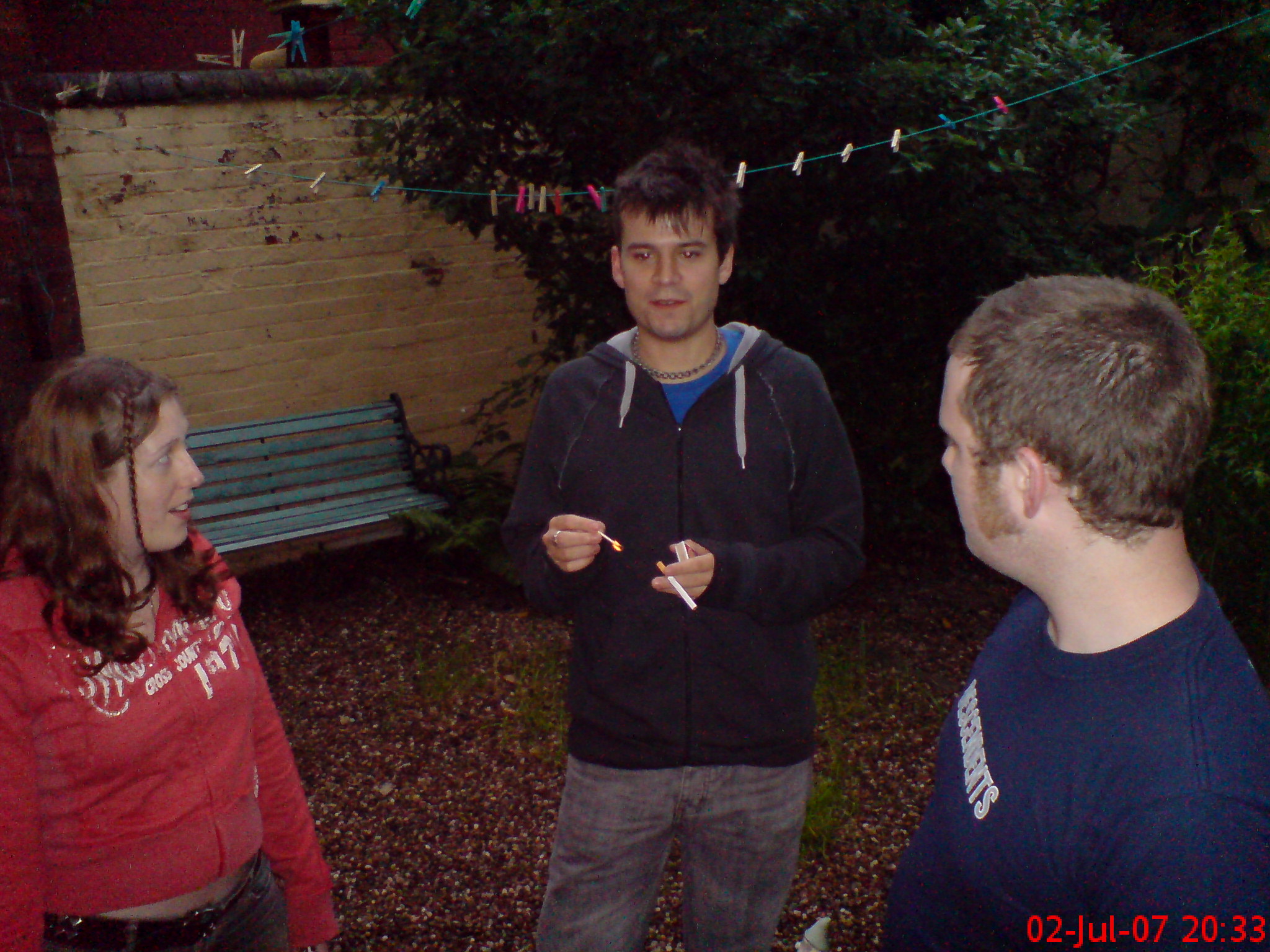 two people standing in the yard with strings in their hands