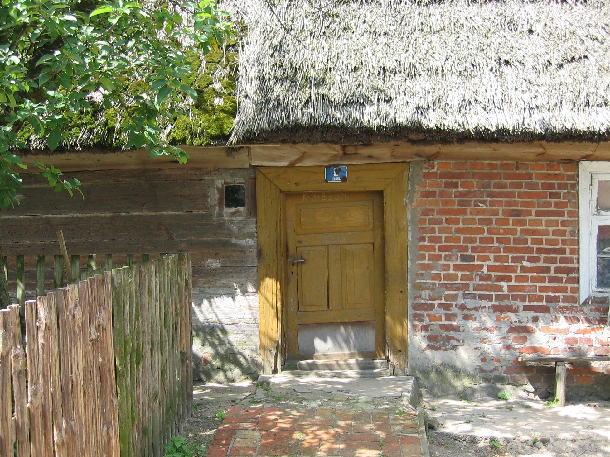 a small, rustic home with a thatched roof