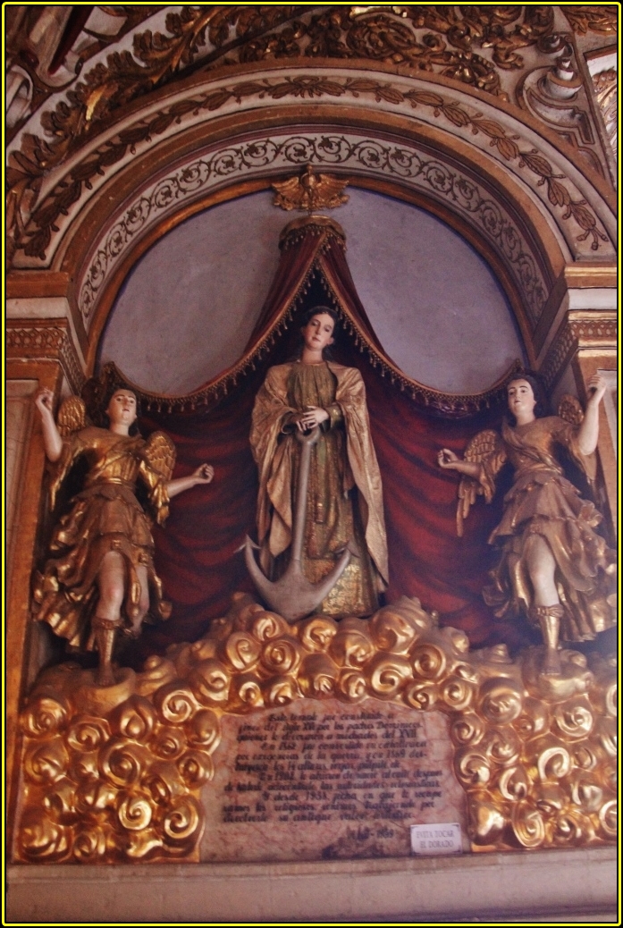 statue displayed in ornate room with elaborate gold border
