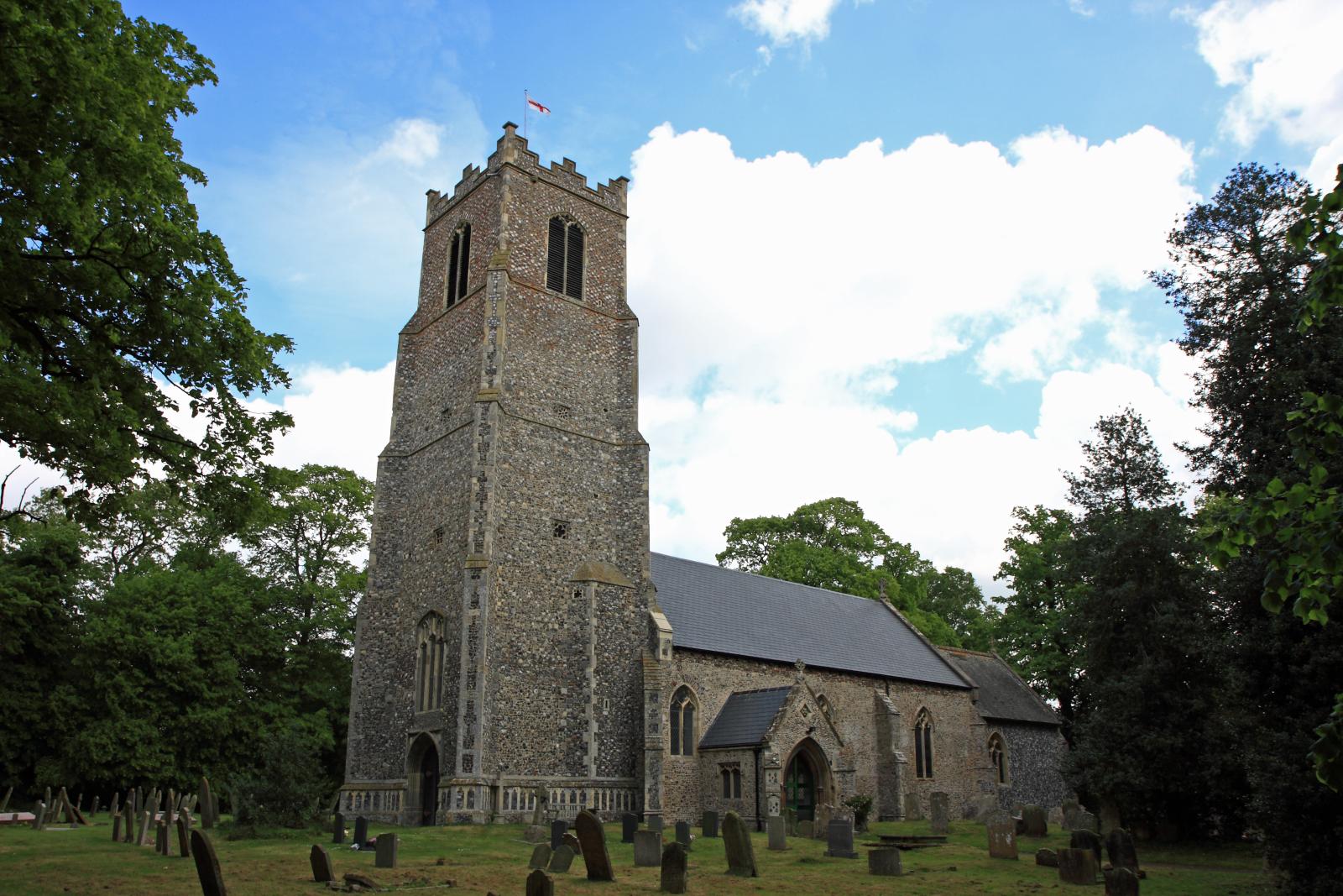 there is a very tall church tower in the yard