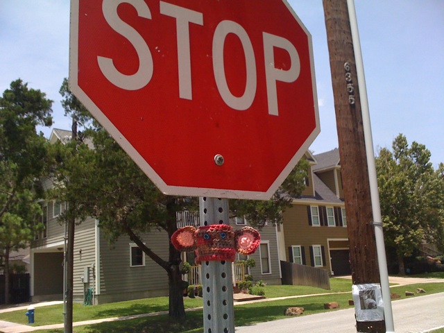 a red stop sign next to a road
