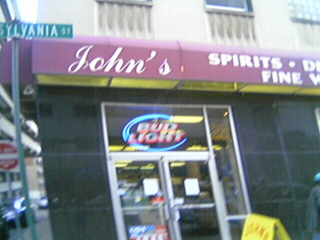 a person walks past a store called john's
