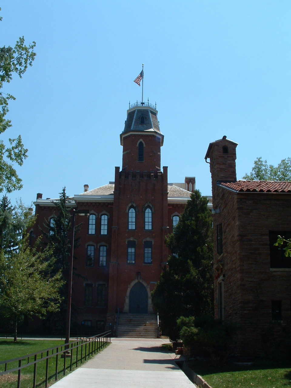 a very tall brick building with a tower on top