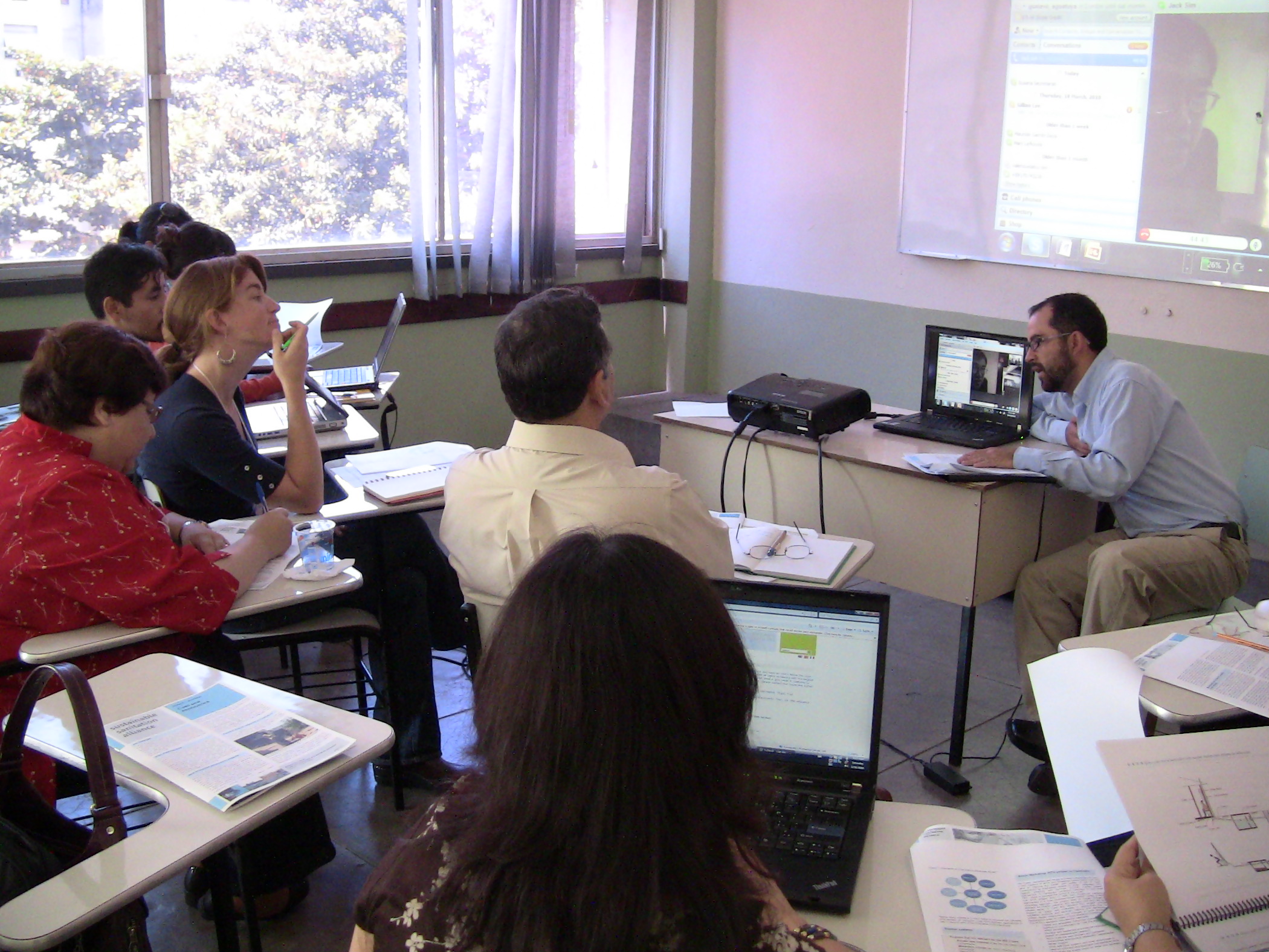 group of adults working on a presentation in classroom