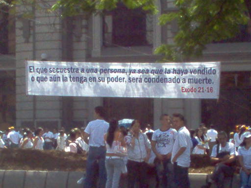 people standing outside a building wearing white shirts