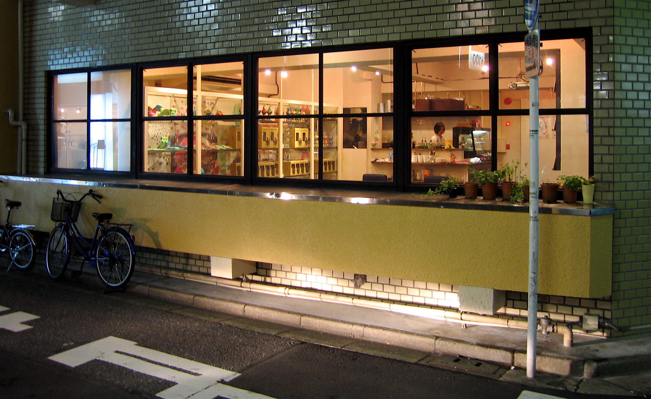 some bicycles parked outside a store at night