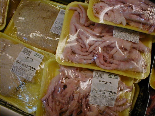 some packaged chickens and other meat in plastic bags