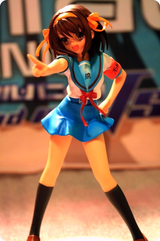 anime toy figurine posed in a skirt and top