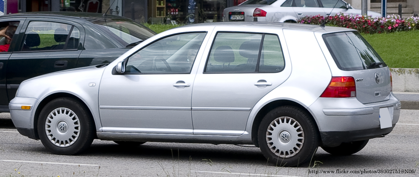 silver volkswagen car parked next to another vehicle