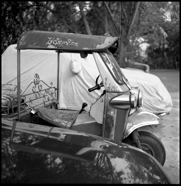 black and white pograph of a street cart covered by a tarp